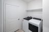 laundry room with tile floors, washer, and dryer