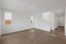 great room with wood floors, white walls, and two windows