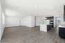 breakfast area with wood floors, white walls, and view of adjacent kitchen with espresso cabinets