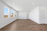 great room with wood floors, white walls, multiple windows, and recessed ceiling lights