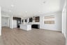 breakfast area with wood floors, white walls, and large window