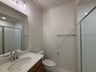 secondary bathroom with a walk-in shower