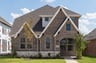 exterior of home with brown brick and white siding