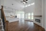 open great room with wood floors and fireplace