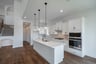 open kitchen with wood floors and island