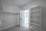 primary bedroom closet with carpet and white shelves