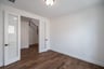 private study with wood floors and windows