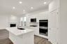 kitchen with white countertops and a built-in sink in the island