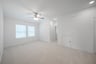 open gameroom with carpet and ceiling fan