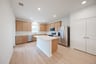 open kitchen with wood floors and island