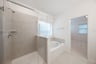 primary bathroom with soaking tub and walk-in shower