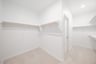 primary bedroom closet with carpet and white shelves