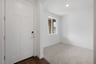 study off entry foyer with light tan carpet white walls and window