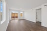 great room with wood floors, white walls, and multiple windows
