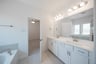 primary bathroom with soaking tub and walk-in shower