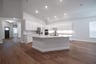 open kitchen with oversized island and hardwood flooring