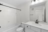 secondary bath with a shower and tub combination