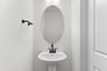 powder room with an oval mirror