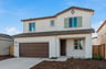front exterior of two-story spanish style home with brown garage door and light green shutters