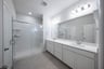 bathroom with large walk-in shower and white countertops 