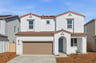 front exterior of white and brown two-story spanish style home with blue front door