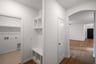 mudroom with cubby storage and next to laundry room 