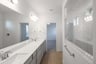 bathroom with white countertops and extra large walk-in shower