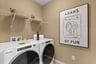 laundry room with a washer, dryer and a shelf