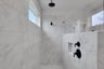 primary bathroom with large walk-in shower with tile