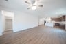 open great room with wood floors and ceiling fan