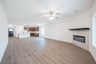 open great room with wood floors and ceiling fan
