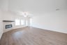 open great room with wood floors and fireplace