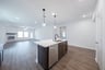 open kitchen with wood floors and island