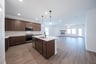 open kitchen with wood floors and island