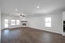open great room with wood floors and fireplace