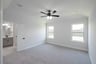 primary bedroom with carpet and ceiling fan