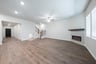 open great room with hardwood flooring and electric fireplace