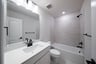 bathroom with bathtub and white countertops 