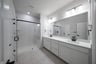 bathroom with large walk-in shower and white countertops 