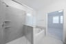 primary bathroom with soaking tub and walk-in shower