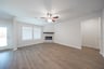 open great room with wood floors and fireplace