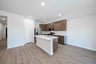 open kitchen with wood floors and island