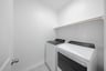 laundry room with tile floors, washer, and dryer
