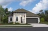 home with brick, windows, garage and landscaped grass 