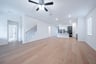 open great room with wood floors and ceiling fan
