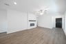 open great room with wood floors and fireplace