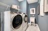 laundry room with wire shelves and a sink