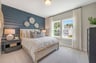 secondary bedroom with two windows and carpet