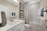 secondary bath with a tub and shower combo