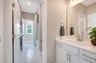 secondary bath with a sink, tub and a window